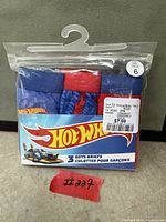Front view of sealed pack showing three briefs and size label