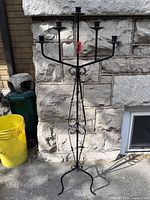 Full view of black wrought iron floor candelabra