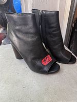 Front and side view of both boots showing leather, peep-toe and zip