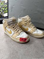 Side view of both shoes showing color, design, and normal wear