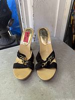 Top view of both mules showing straps, chain detail, insole branding and size sticker