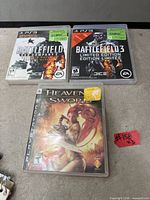 Front view of three PS3 game cases: Battlefield Bad Company 2, Battlefield 3 Limited Edition, Heavenly Sword