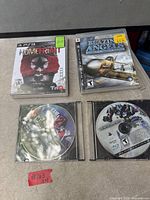 Overview showing four PS3 titles: two cased, two loose discs