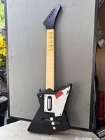 Front view of the black Niko Front Man wireless guitar controller displaying buttons and controls
