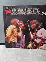 Front gatefold jacket showing Bee Gees on stage