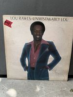 Front cover of Unmistakably Lou LP showing artist image and title with wear visible