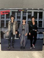 Front cover of Phantom, Rocker & Slick LP showing trio and lot number sticker