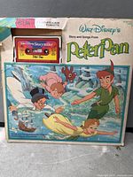 Front view of album sleeve showing cassette inserted and artwork