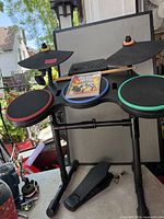 Full drum set with cymbals, pads, drum sticks and game case displayed