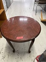 Top view of round walnut table showing surface condition
