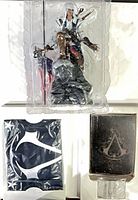 Statue in inner plastic tray, flag package, notebook, buckle