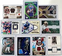Overall view of all 10 memorabilia and rookie cards in toploaders