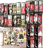 Group shot: 11 boxed mini sticks arrayed above shrink-wrapped calendar