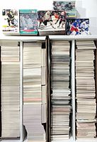 Three long rows of hockey trading cards standing in sorting boxes