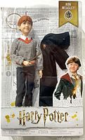 Front of sealed package showing Ron Weasley doll, wand, robe