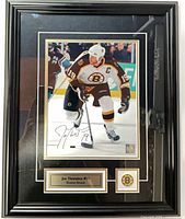 Front view of framed autographed Joe Thornton photo with nameplate and Bruins logo