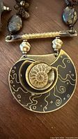 Close-up of handcrafted fossil shell pendant