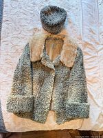 Coat front view with matching hat displayed