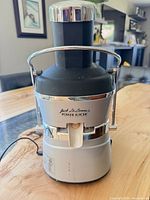 Front view showing Jack LaLanne branding, chrome spout, power cord attached