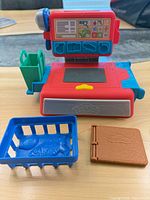 Cash register main unit, green shopping bag, blue basket, brown mold book