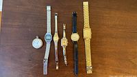Group view of all six timepieces lined up on table