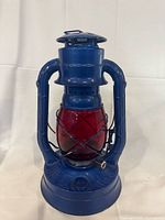 Front view of blue Dietz No. 80 lantern with red globe