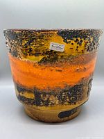 Front view showing glaze bands and label