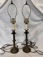 Front view of both brass table lamps with harps and cords