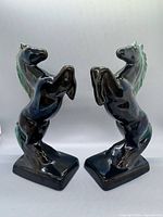 Front view of both ceramic rearing horse bookends
