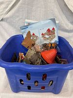 Overall lot in blue bin showing assorted castle parts and manuals