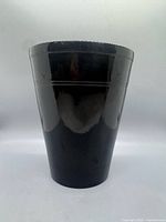 front view of glossy black tapered ceramic planter