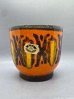 Front view showing abstract glaze pattern and foil label
