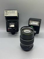 Group shot of Hanimar 135mm lens with Black’s STD-50 flash and T85 Quick Dedicated flash