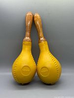 Front view of pair showing yellow bodies and wood handles