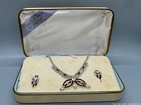 Necklace and earrings displayed in original Jay Kel case