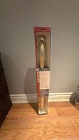Boxed 24" brass-plated grab bar standing upright