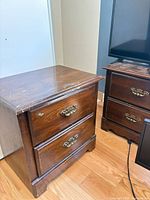 Front and side view of one nightstand showing drawer fronts and handles