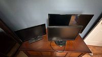 Overview of three flat-screen units on cabinet