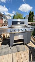 Full view of Cuisinart stainless steel propane gas grill on deck