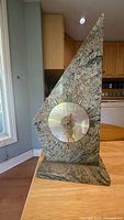Front view showing granite body, clock face, numerals, hands and base