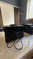 Front view of stacked Kenwood components with cabling visible