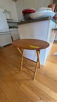 Full view of oval folding side table beside kitchen island