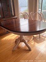 Tabletop close-up showing oval shape and pedestal center seam