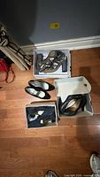 All four pairs of shoes displayed on floor and in boxes