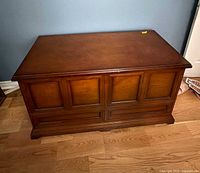 Front and top view of blanket chest showing paneled design and finish