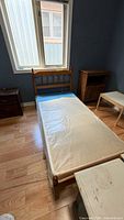 Overall view of twin bed frame with headboard, footboard and box spring