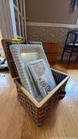 Overall lot showing basket, mirror and model kit inside basket