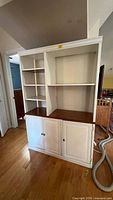 Front view of full bookcase showing shelves and cabinet