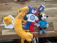 Front view of all four plush toys grouped together