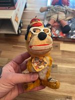 Front view of Bingo plush showing glasses, hat, tag and overall wear
